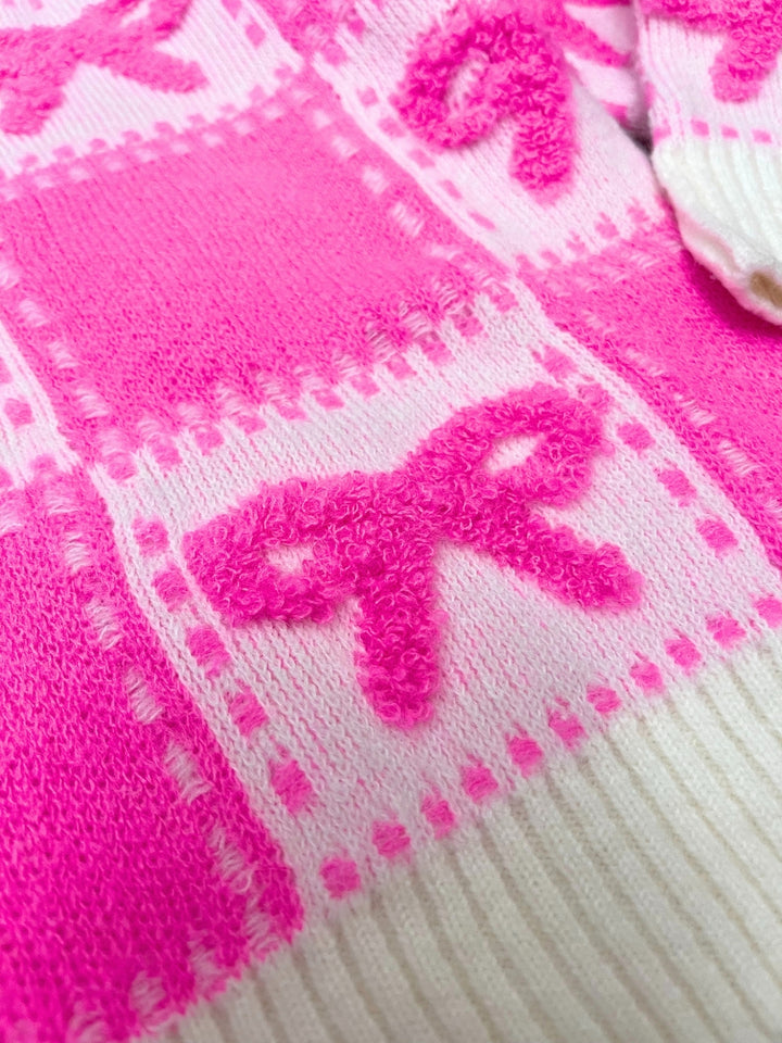 Close up of pink bow patchwork knit sweater fabric texture