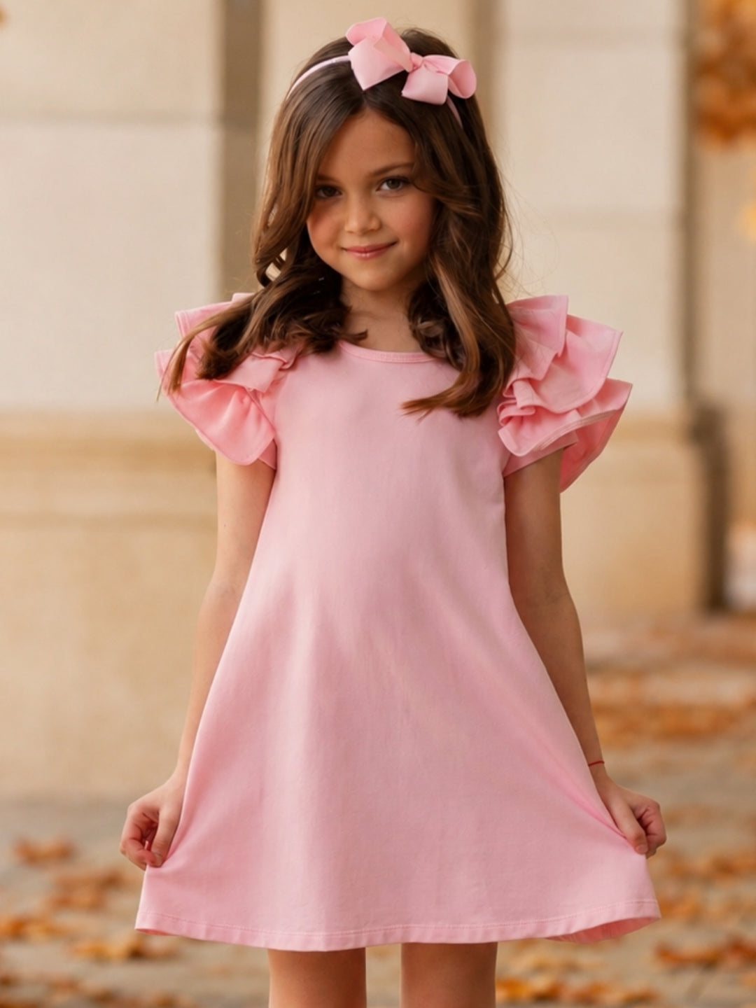 Girls pink flutter sleeve dress with relaxed fit.
