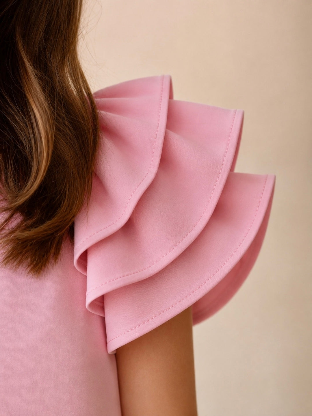 Girls pink knit dress with layered flutter sleeves.