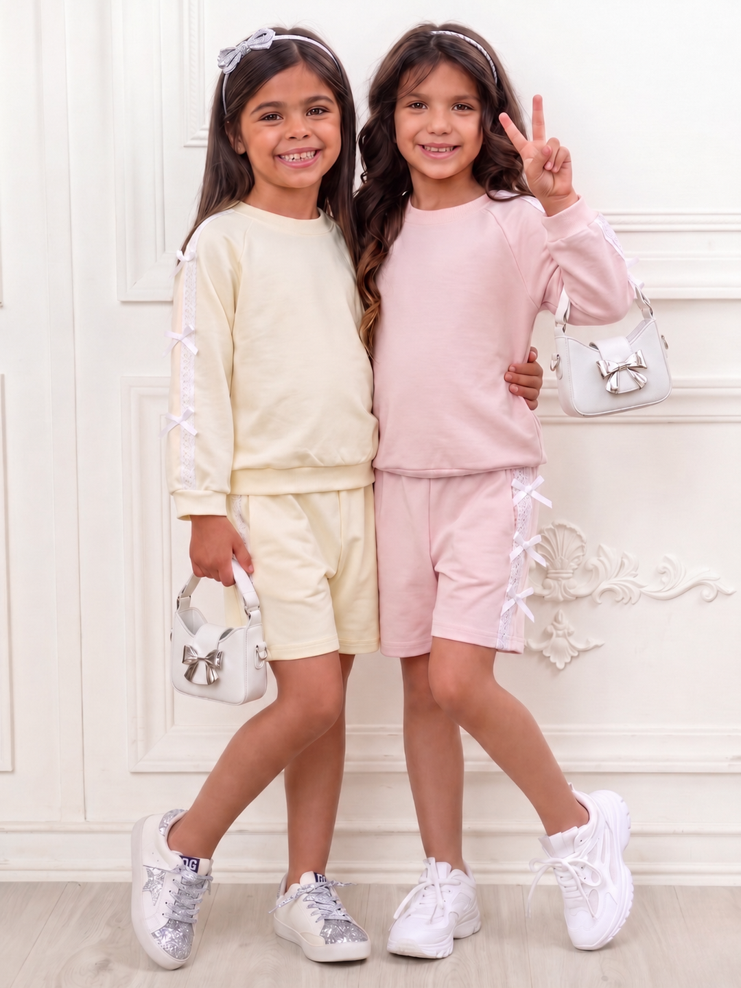 Girls pink and yellow sweatshirt and short set with lace bow details