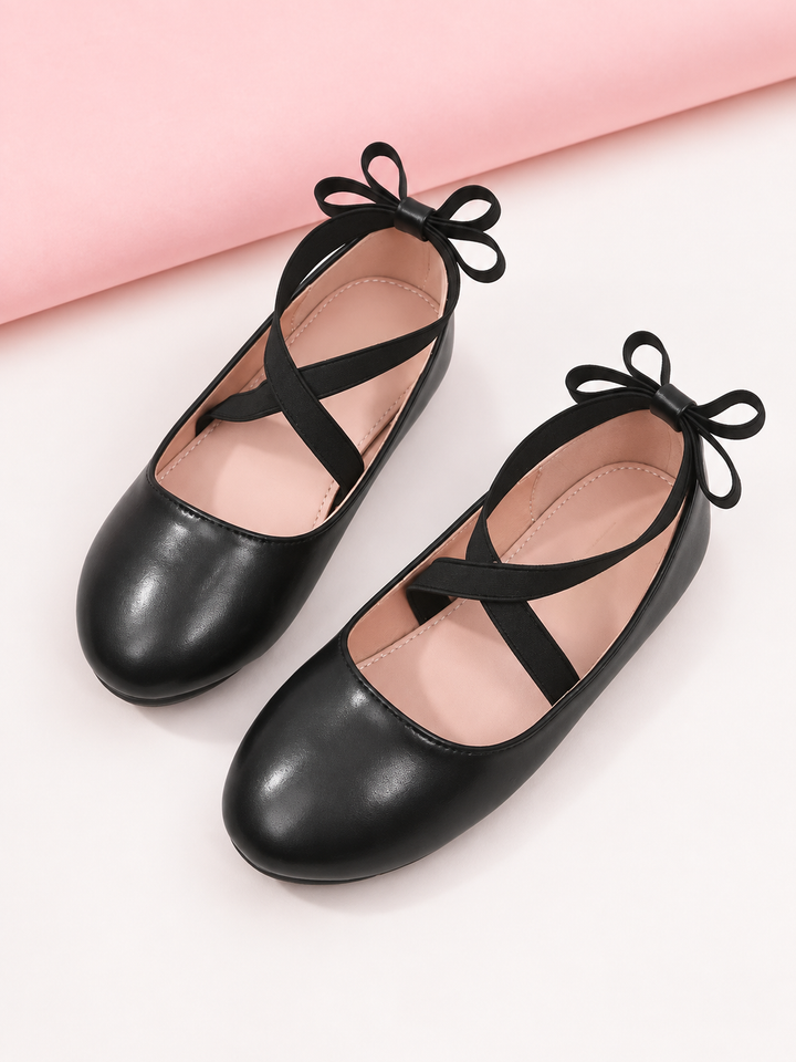 Girls black ballet flats with crisscross straps and bow details