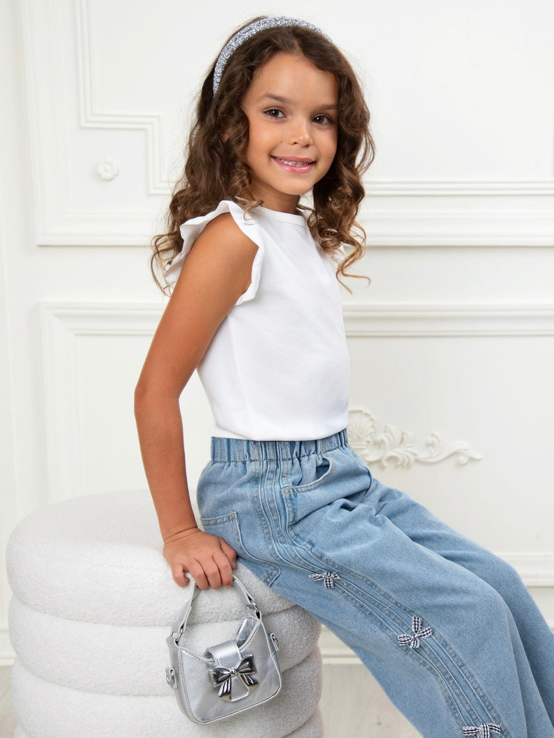 Fashion girls denim jeans with side bow embellishments
