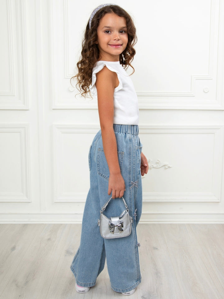Light wash girls jeans with elegant bow details and relaxed fit
