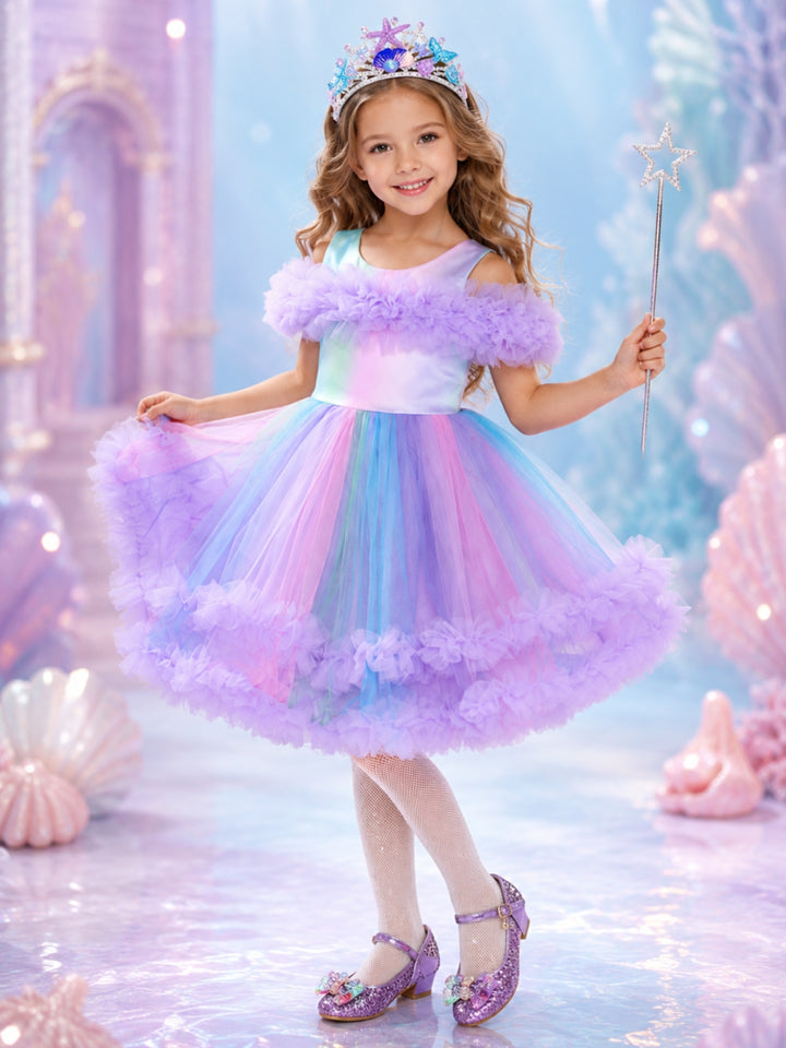 Girl wearing a Pastel Sea Princess Halloween costume with a rainbow pastel dress.