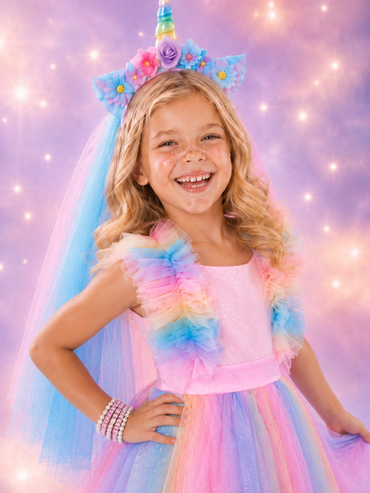 Girls unicorn costume with pastel rainbow colors and glitter details.