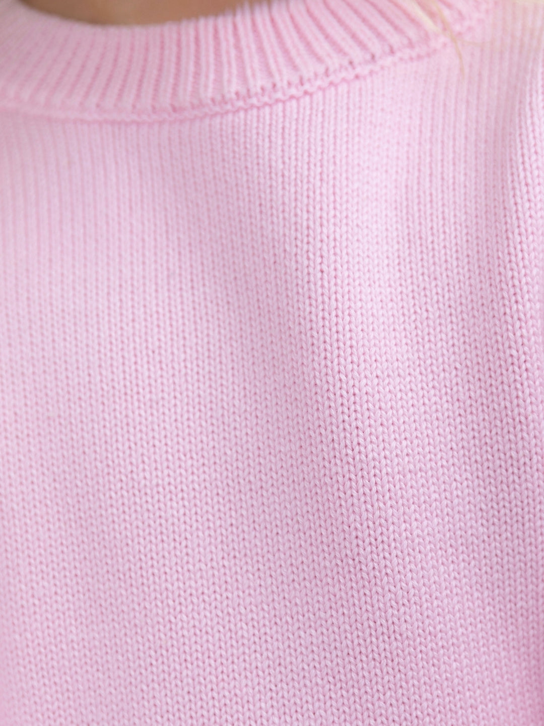 Stylish girls pink sweater with ribbed knit texture