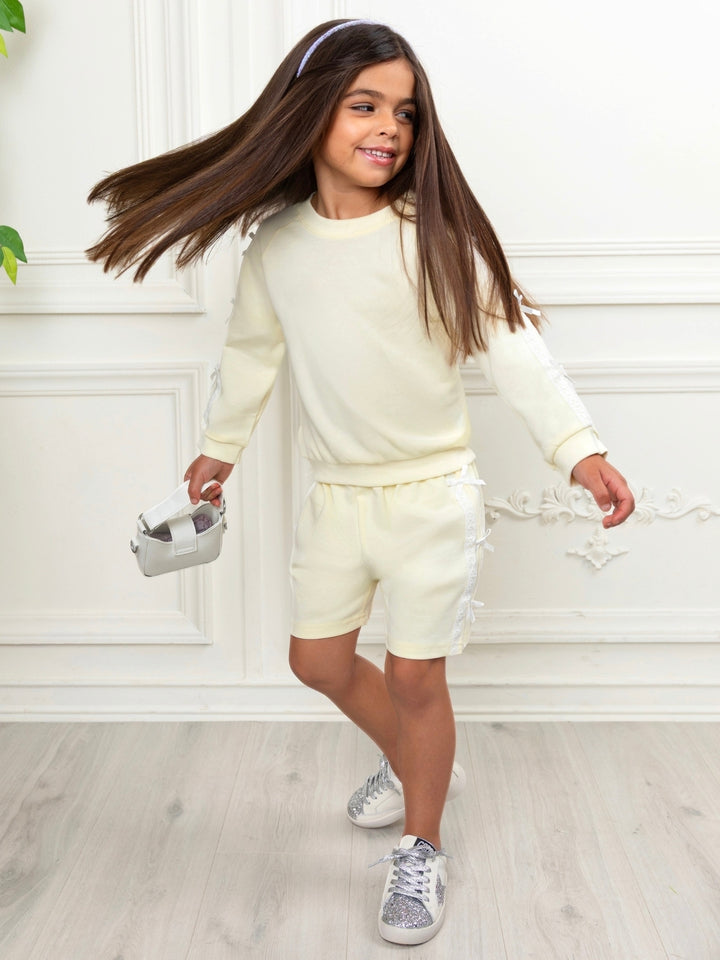 Yellow girls matching outfit featuring lace trim and ribbon bows