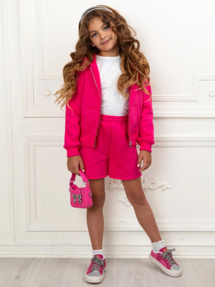 Girls matching hoodie and shorts outfit in vibrant pink