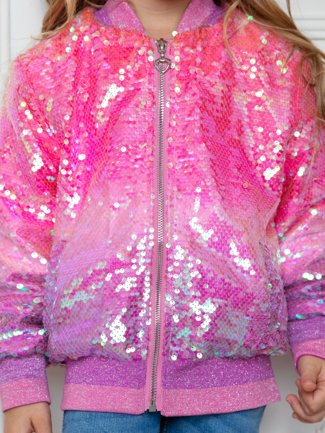 Little girl wearing pink sequin bomber jacket for birthday party outfit