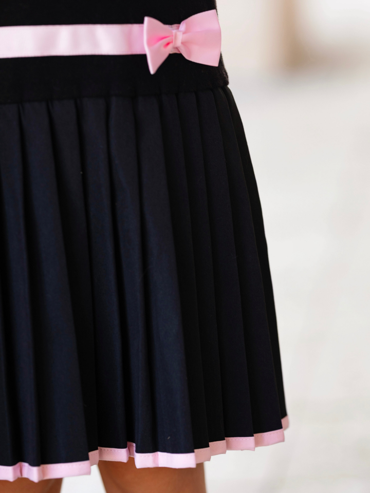 Black sweater dress and a pleated skirt with bows for fall and holiday special occasions.