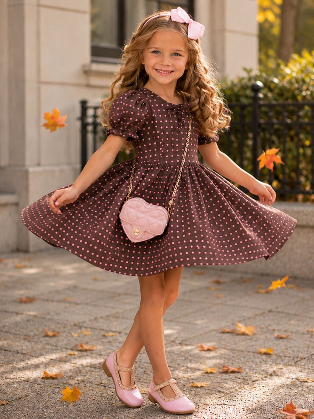 Girls brown fall dress with blush pink polka dots and bow neckline.