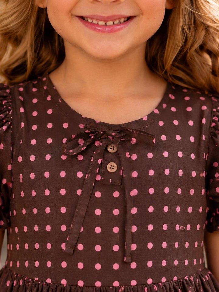 Girls brown fall dress with blush pink polka dots and bow neckline.