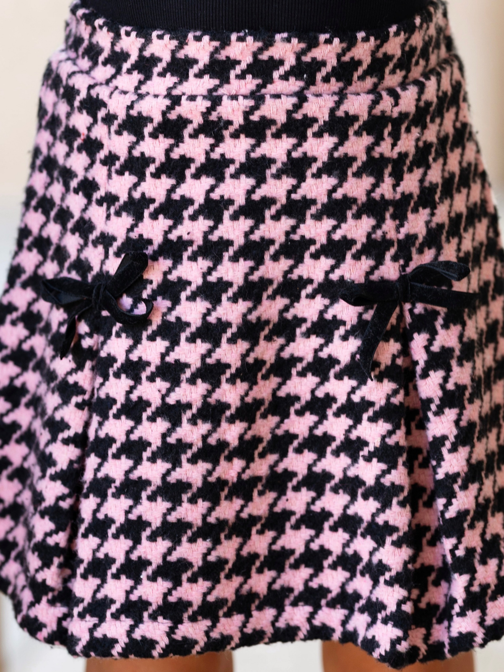 Girl wearing a pink houndstooth skirt for fall special occasions