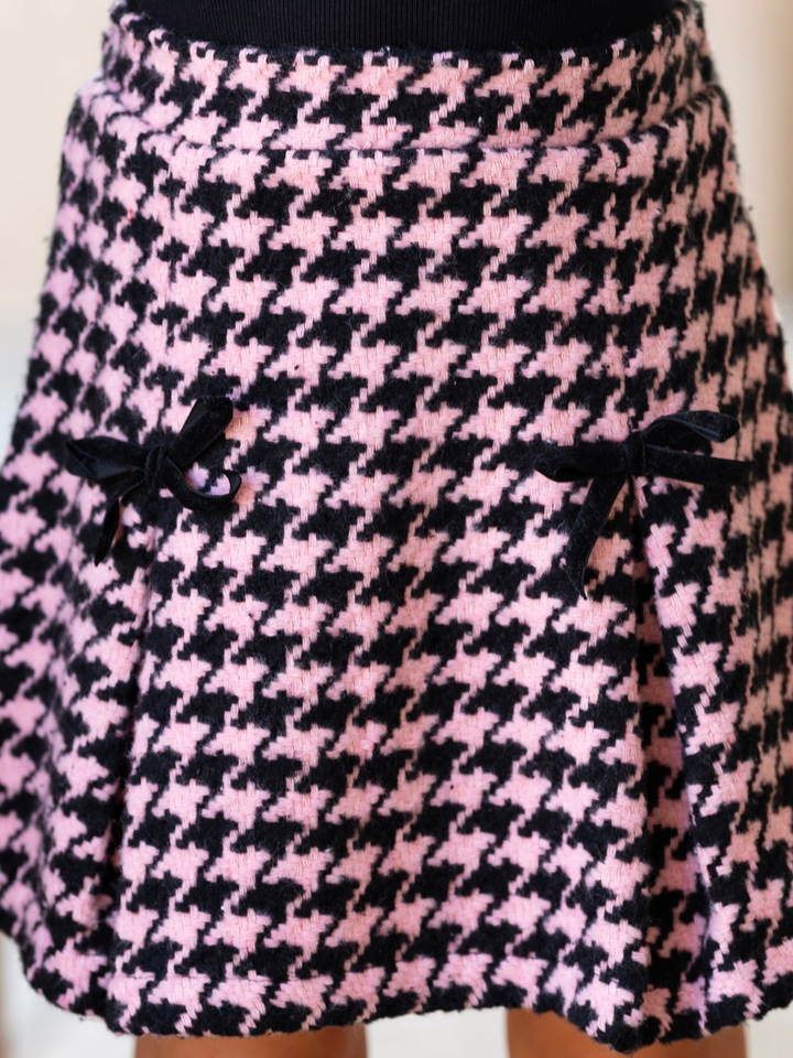 Girl wearing a pink houndstooth skirt for fall special occasions