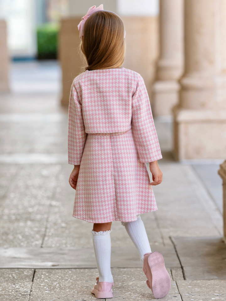 Girl wearing a pink houndstooth dress with a matching cropped jacket for fall and holiday special occasions.