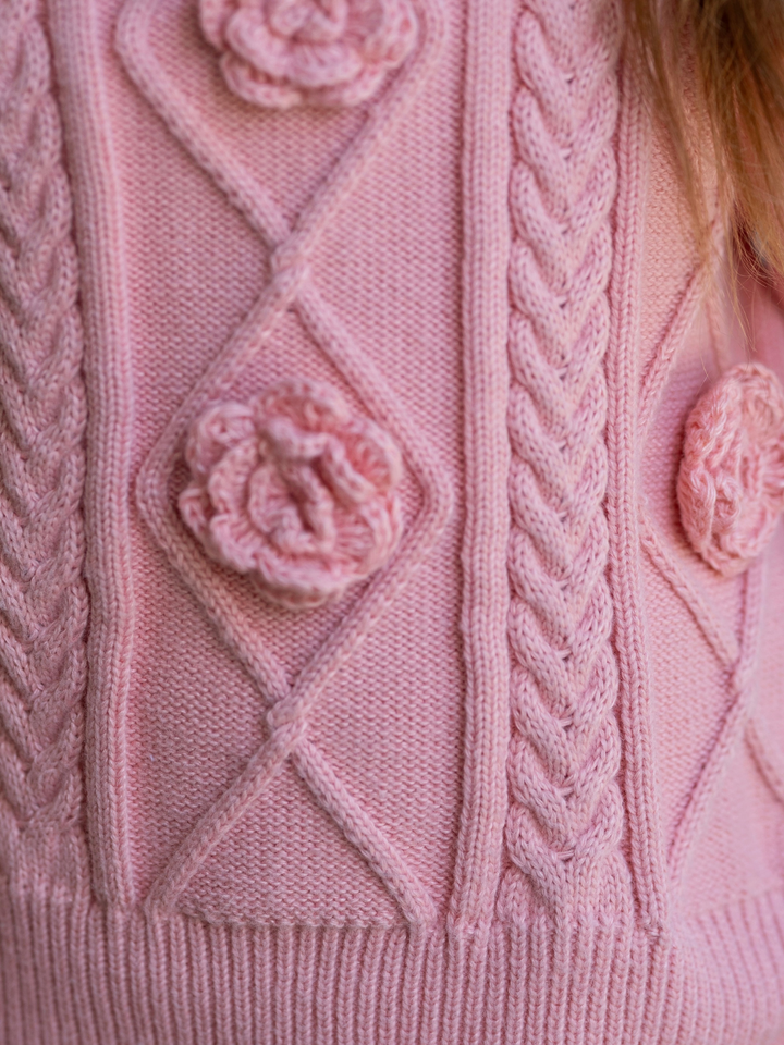 Pink girls cable knit sweater with floral rosette details for fall special occasions