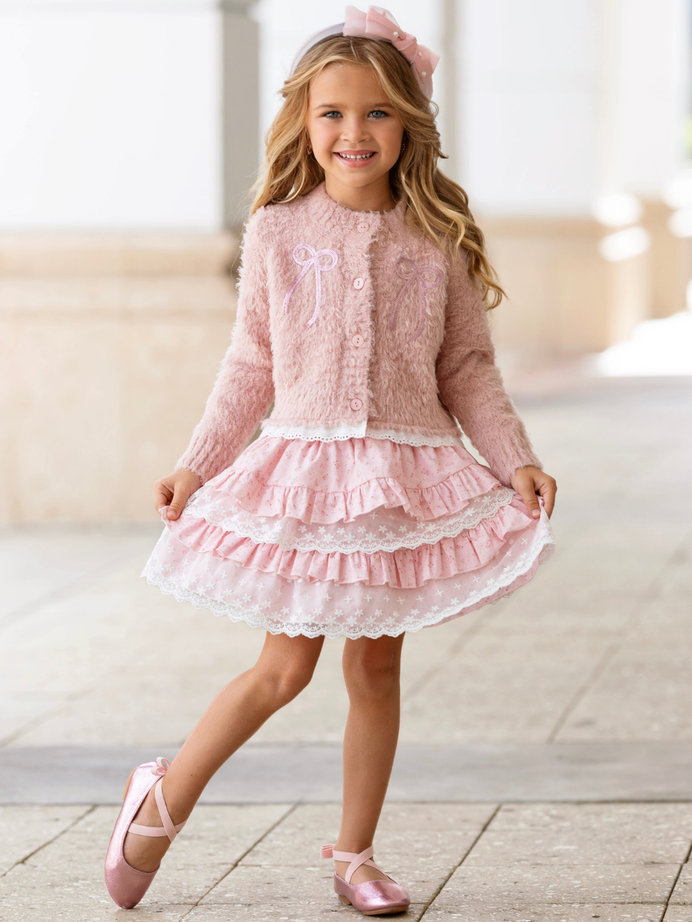 Girls cardigan and lace skirt set featuring embroidered bows and soft knit fabric.