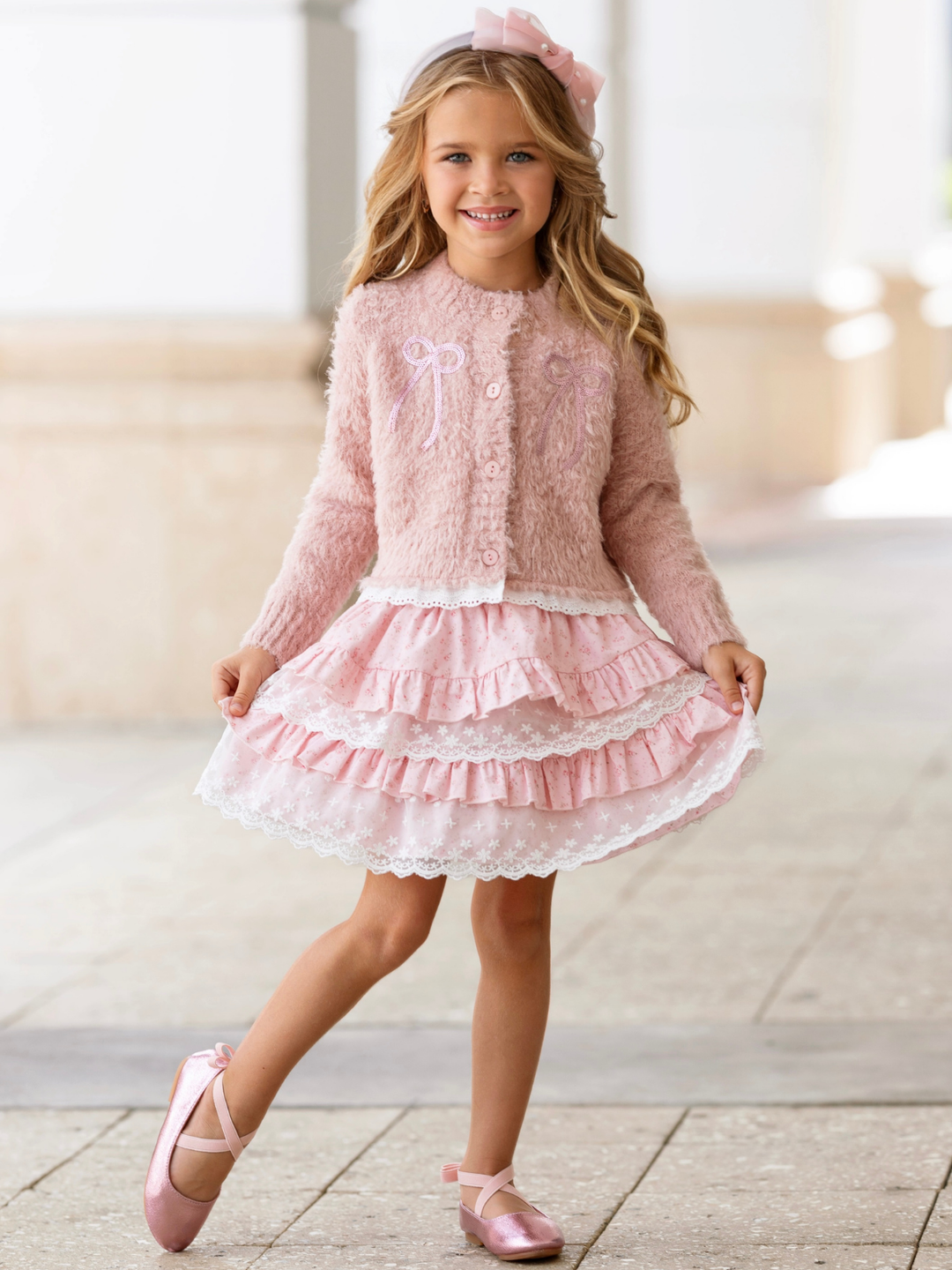 Girls cardigan and lace skirt set featuring embroidered bows and soft knit fabric.