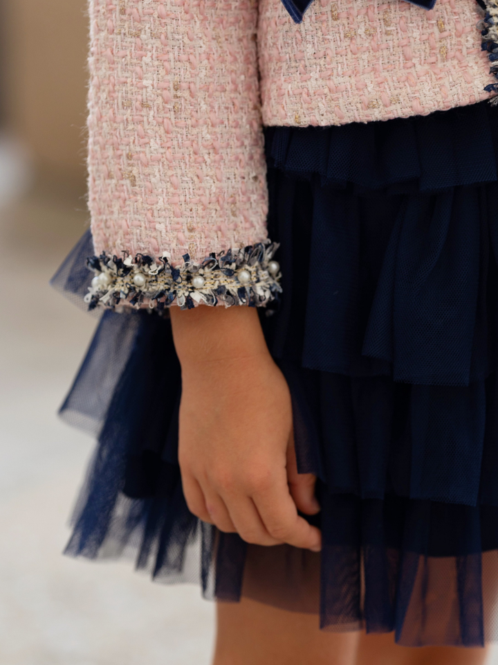 Girls blush tweed jacket with a layered navy tulle skirt.