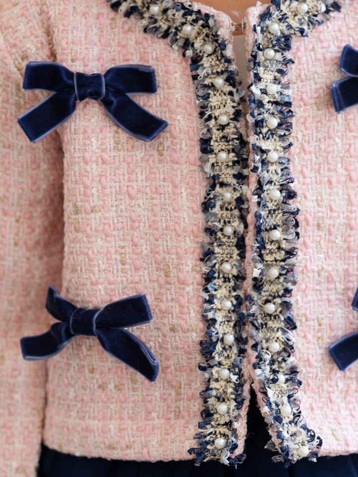 Girls tweed jacket with navy elegant bow accents and tweed material.