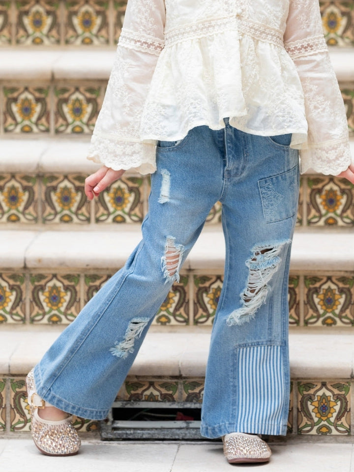 Girls distressed straight-leg jeans with patchwork details.