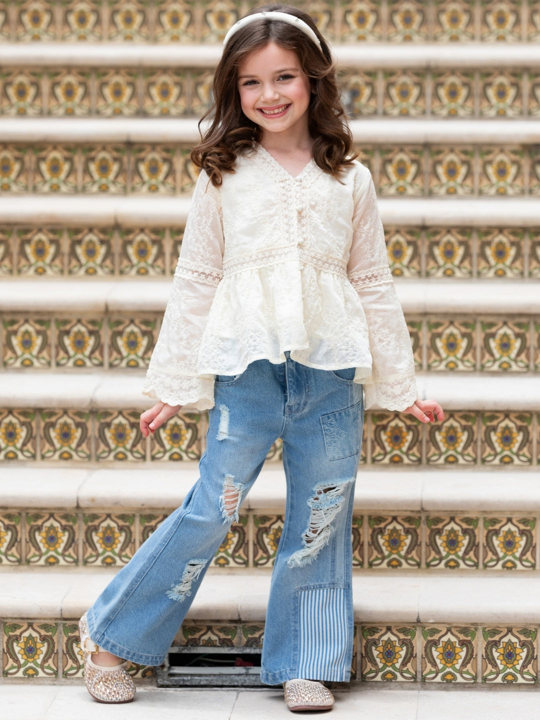 Girls trendy distressed denim pants.
