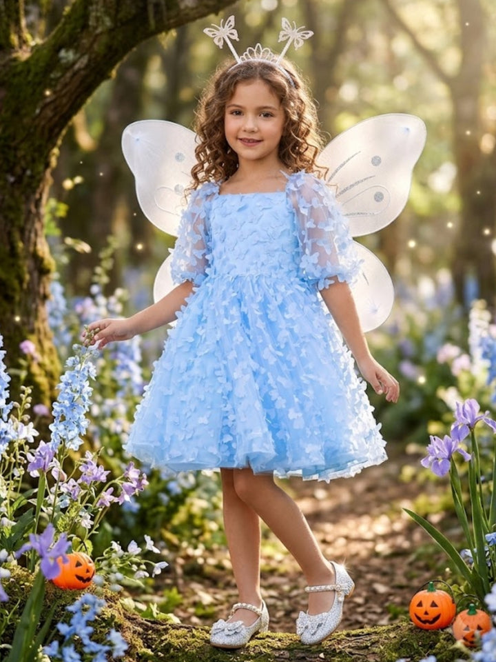 Girl wearing an Enchanted Blue Butterfly Fairy Halloween costume with a blue butterfly dress.