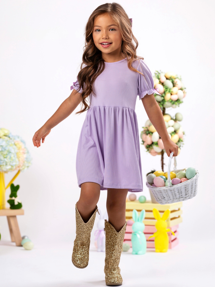 Little girl in lavender short sleeve dress with satin bow details