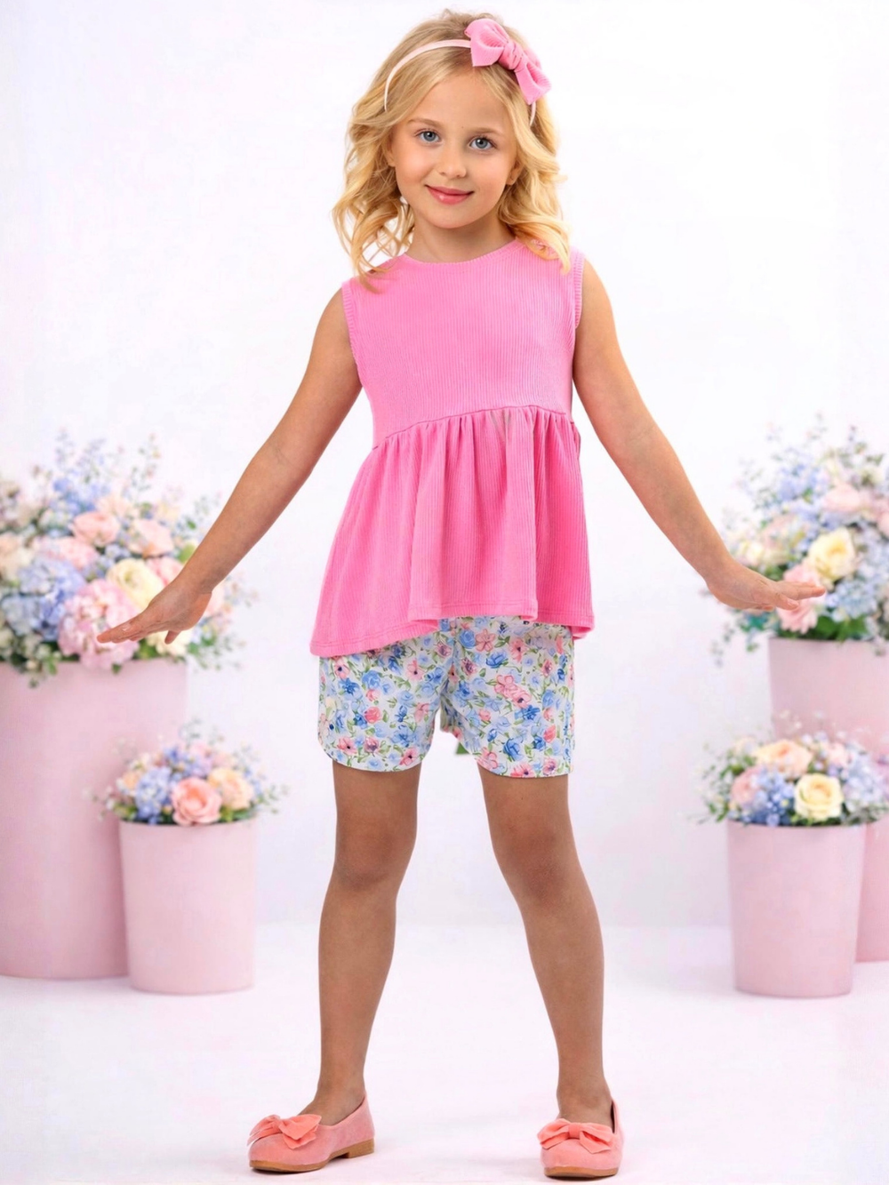 Girl modeling pink top and floral shorts for everyday wear