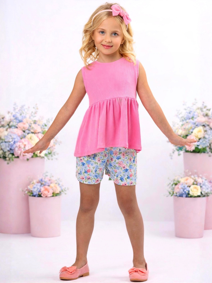 Girl modeling pink top and floral shorts for everyday wear