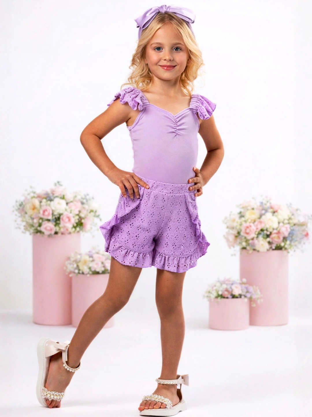 Girl wearing lavender eyelet short set with ruffle shorts for spring outfit