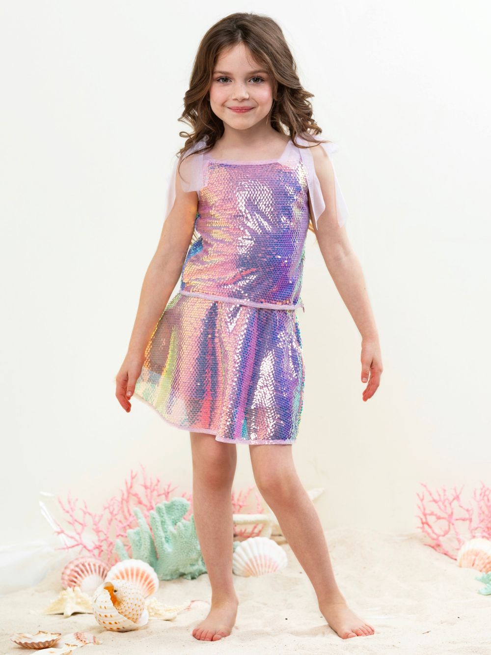 Girl wearing iridescent sequin skirt set with shimmer top for party outfit