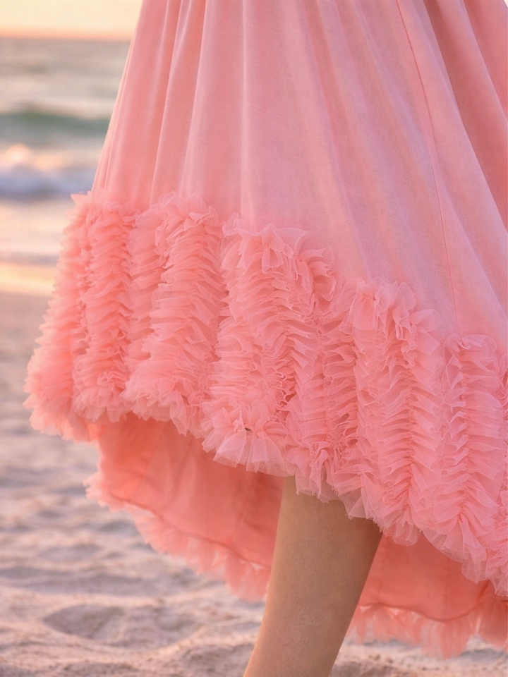 Girl wearing elegant coral dress with layered ruffle detail