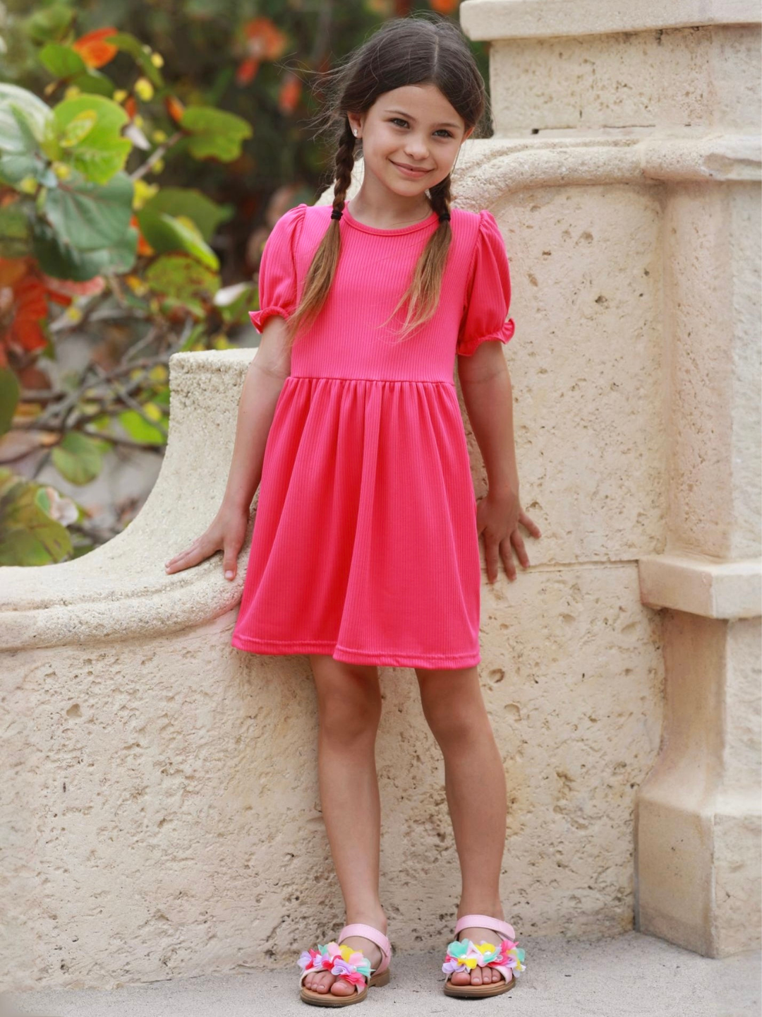girl wearing bright pink summer dress with puff sleeves casual outfit
