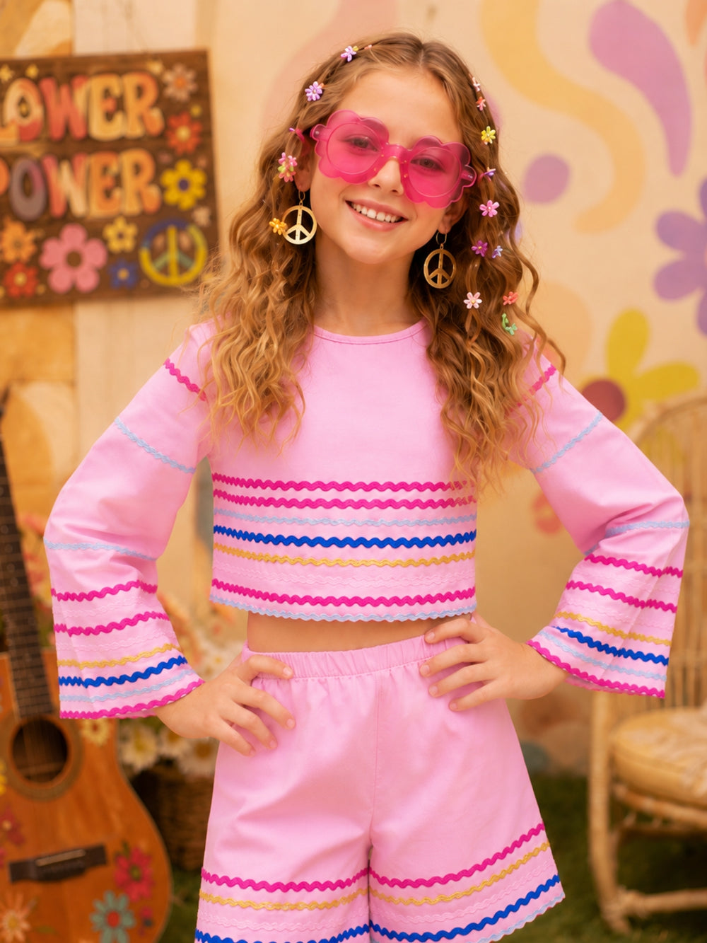 Groovy daisy hippie costume for girls featuring flared sleeves and matching shorts.