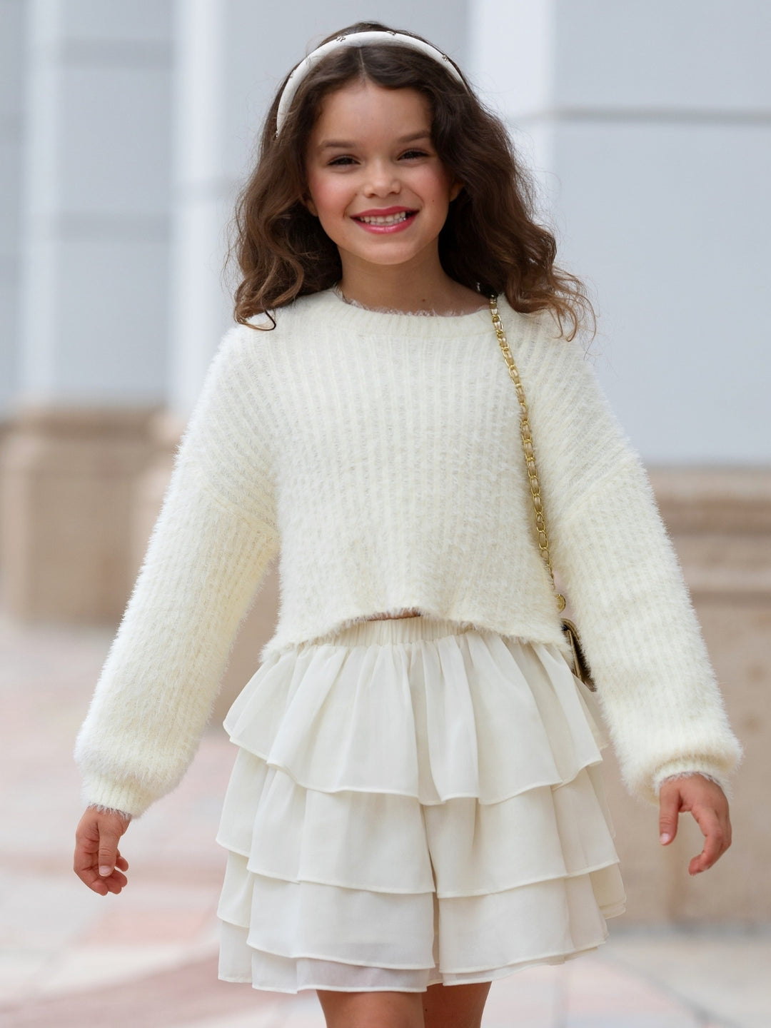 Girls fall outfit with knit sweater and tiered skirt.