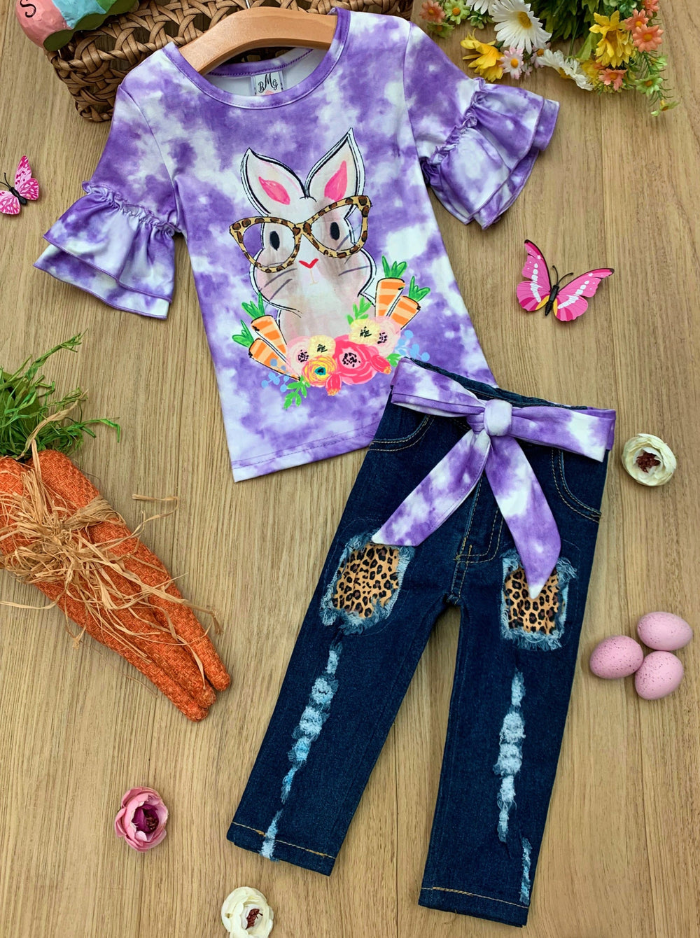 Girls Easter-themed set features a purple tie-dye top with bunny graphic and leopard print patched jeans with sash for 2T to 10Y toddlers and girls