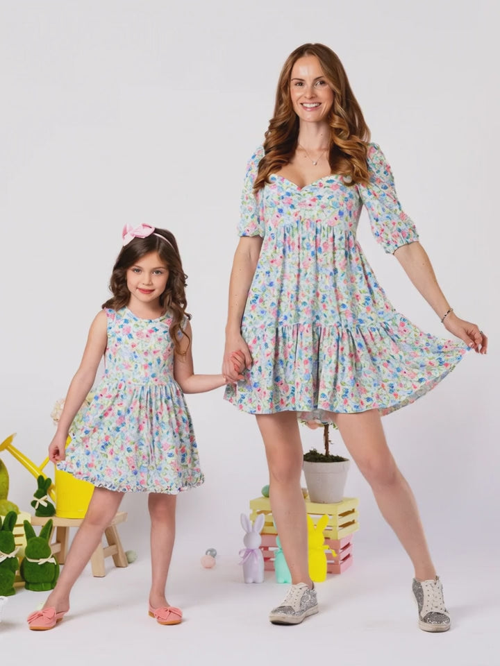Mom and daughter twinning in lightweight floral dresses for warm weather